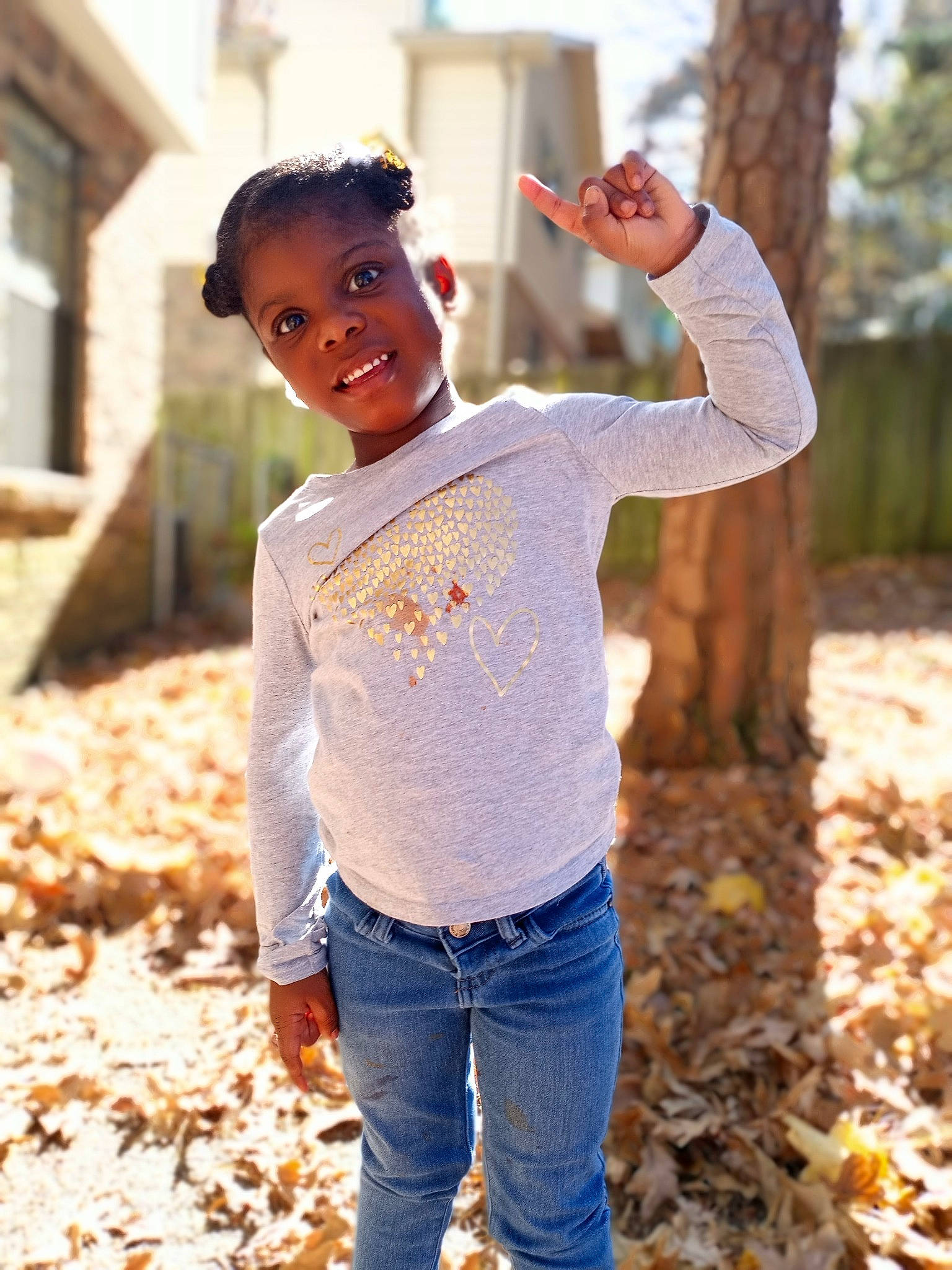 Kendall Kylie And Khloe is registered to the contest to win money with this photo: child, cool, denim, fun, gesture, jeans, joy, leaf, neck, person, photo_shoot, photography, plant, shoulder, sleeve, smile, standing, sweater, t_shirt, toddler