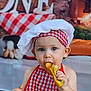 toddler, child, chef_hat, apron, spaghetti, bread, food, messy, eating, plate, table, curious, blue_eyes, indoor, portrait, cute, foodie, baby, meal, red_checkered