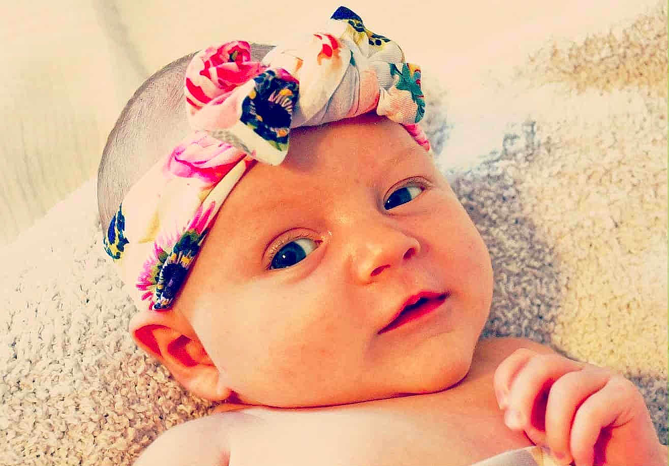 Esmeray joined the competition — help win amazing prizes! baby, child, closeup, cute, expression, eyes, face, floral, hand, headband, indoors, infant, innocent, lying_down, person, portrait, skin, soft, texture, young