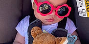 Ava participe au concours pour gagner de l'argent avec cette photo : baby, car_seat, sunglasses, headband, teddy_bear, blanket, pacifier, bracelet, sunlight, clothing, infant, child, seatbelt, cute, toy, accessory, relaxing, indoors, portrait, sleeping