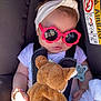 baby, car_seat, sunglasses, headband, teddy_bear, blanket, pacifier, bracelet, sunlight, clothing, infant, child, seatbelt, cute, toy, accessory, relaxing, indoors, portrait, sleeping