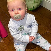 Cobie Lewis joined the competition — help win amazing prizes! toddler, child, pacifier, pajamas, dinosaur_pattern, wooden_floor, indoor, laundry_basket, clothing, sitting, curious, blond_hair, baby, flooring, long_sleeve, pants, person, home, infant, casual