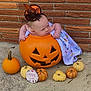 Nevaeh is registered to the contest to win money with this photo: baby, pumpkin, jack_o_lantern, hat, witch_hat, milestone_sign, five_months, small_pumpkins, orange, yellow, blanket, outdoor, concrete, brick_wall, cute, festive, halloween, holiday, child, costume