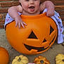 baby, pumpkin, jack_o_lantern, smiling, drool, five_months, blanket, brick_wall, fall_decor, cute, infant, orange, decorative_pumpkins, happy, child, outdoor, seasonal, autumn, holiday, playful