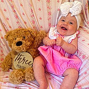 Denver is registered to the contest to win money with this photo: baby, bed, bedroom, clothing, couch, cushion, face, furniture, hat, head, homedecor, indoors, newborn, person, photography, portrait, room, sitting, teddybear, toy