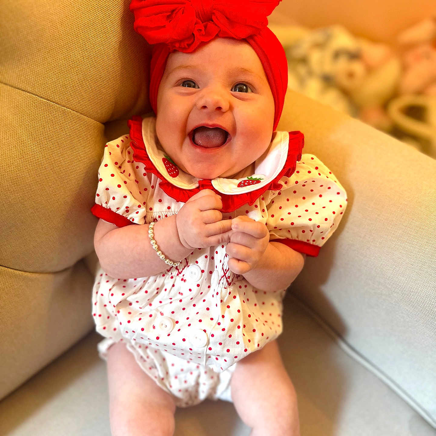 Denver is registered to the contest to win money with this photo: accessories, baby, babylaughing, clothing, couch, cushion, dress, face, furniture, happy, hat, head, homedecor, jewelry, laughing, necklace, person, photography, portrait, sitting
