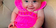 Denver is registered to the contest to win money with this photo: baby, cap, clothing, costume, couch, cushion, dress, face, flower, furniture, hat, head, homedecor, person, petal, photography, plant, portrait, sitting, swimwear