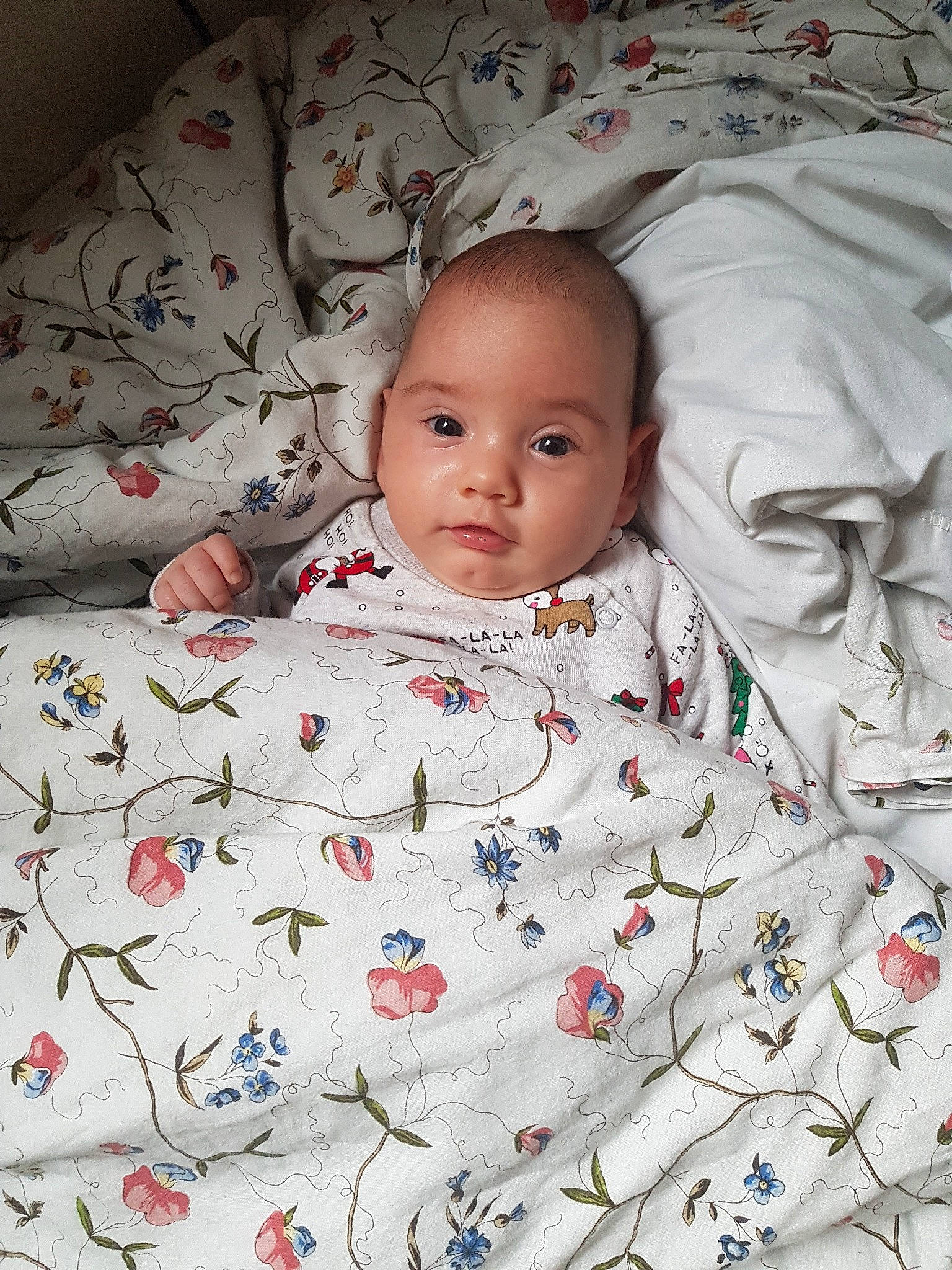 Melania is registered to the contest to win money with this photo: baby, bedding, bedtime, blanket, cheek, child, linens, person, skin, smile, textile, toddler