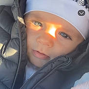 Djayden participe au concours pour gagner de l'argent avec cette photo : baby, blanket, blue_eyes, child, closeup, cozy, face, hat, headwear, infant, jacket, outdoor, portrait, puffy_jacket, soft_texture, sunlight, warm_light, winter_clothing, young_child, zipper