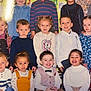 children, group_photo, classroom, smiling, diverse, young_children, teacher, colorful_wall, playful_art, casual_clothing, sitting, standing, portrait, happy, indoor, school, friends, kids, childhood, fun