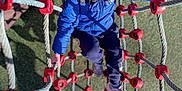 Oconnor participe au concours pour gagner de l'argent avec cette photo : child, climbing, playground, rope_net, blue_jacket, smiling, outdoor, sunlight, shadow, happy, boy, toy, play, rope, net, casual_clothing, daylight, activity, young, fun