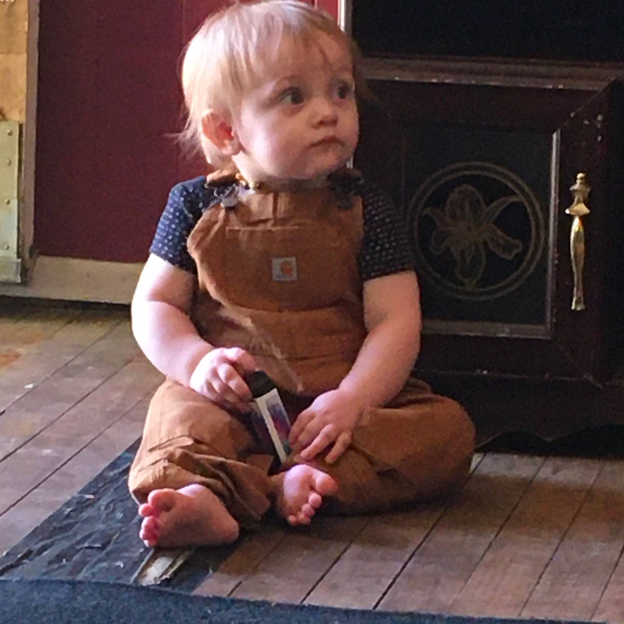 Coraline is registered to the contest to win money with this photo: baby, blond, child, floor, flooring, hand, human, leg, person, sitting, toddler, wood