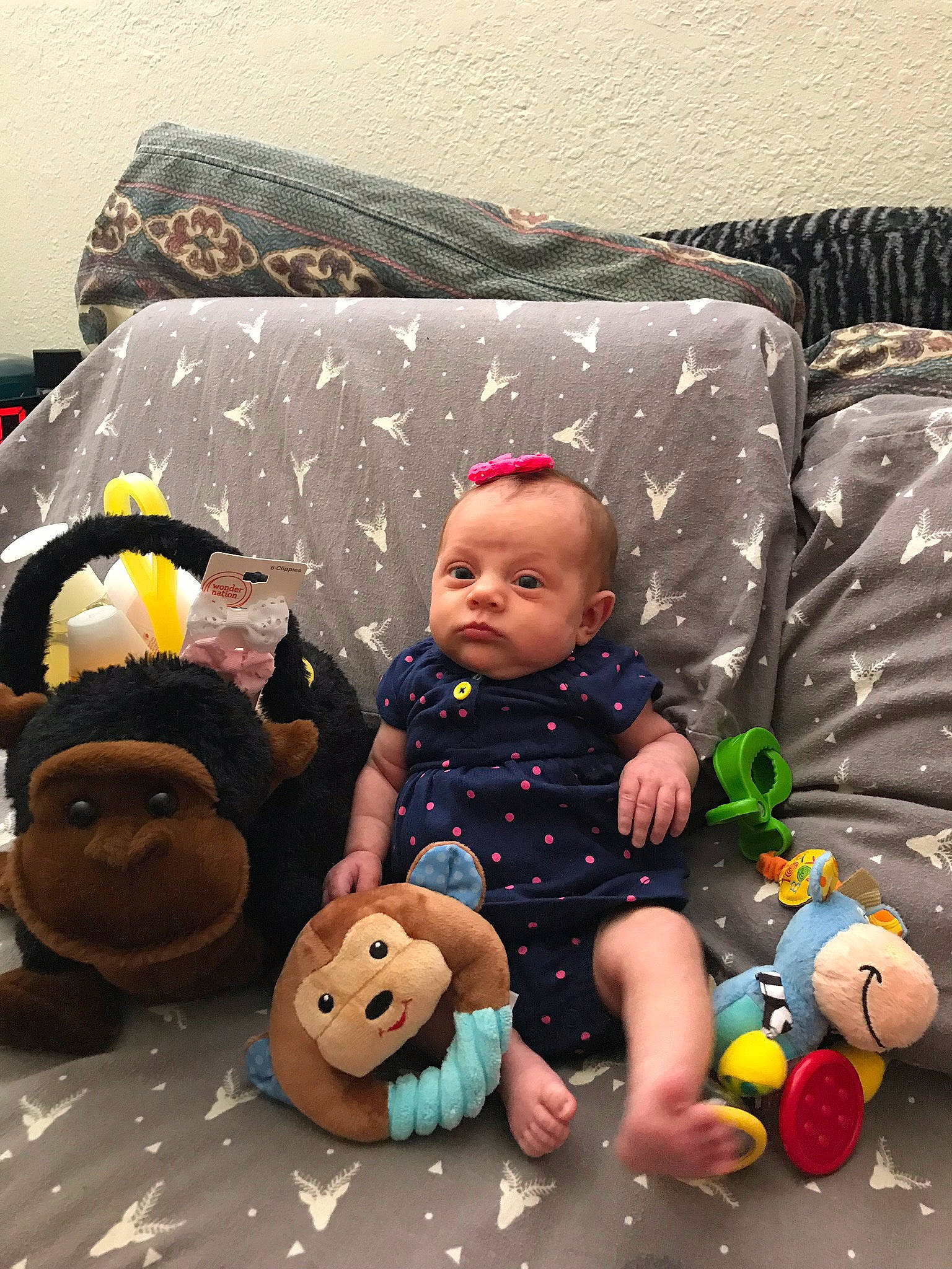 Coraline is registered to the contest to win money with this photo: baby, baby_toys, brown, cheek, child, head, headwear, person, play, room, sitting, skin, stuffed_toy, toddler, toy, yellow