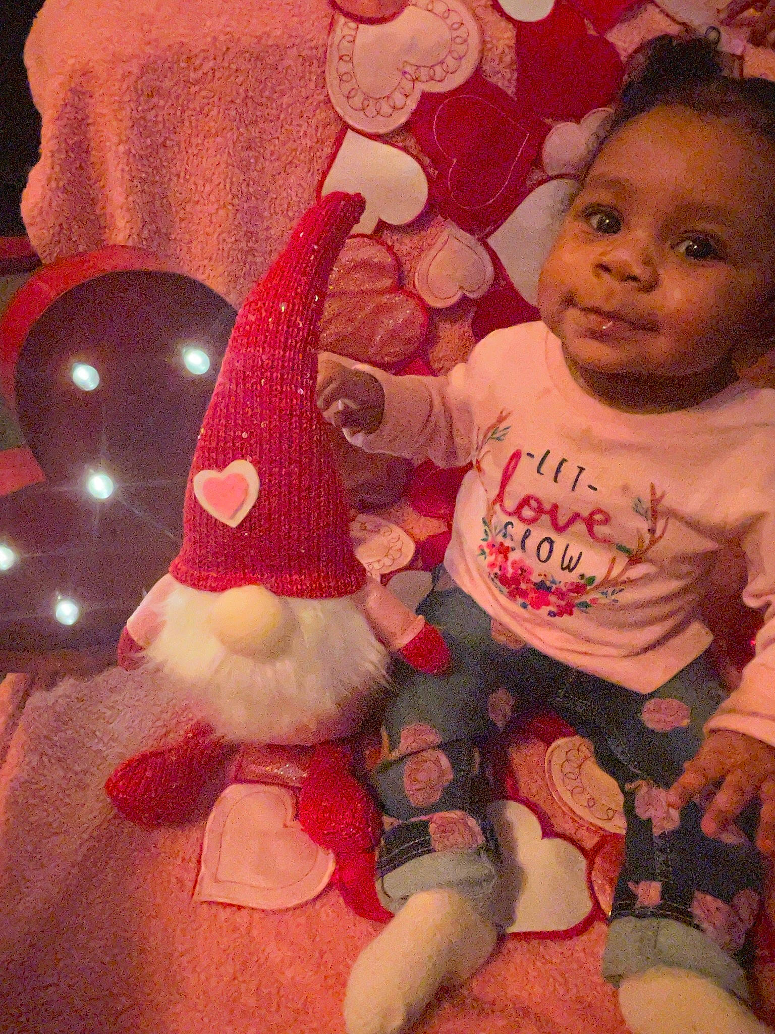 Demi joined the competition — help win amazing prizes! baby, baby_toddler_clothing, carmine, cheek, costume_hat, event, happy, holiday, human_body, lap, linens, magenta, pattern, person, pink, room, skin, sleeve, sock, textile