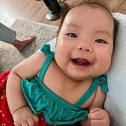Haylen joined the competition — help win amazing prizes! baby, child, clothing, cushion, cute, face, floor, foot, furniture, green_top, hair, happy, indoor, infant, people, polka_dot, portrait, red_skirt, smiling, wood_floor