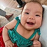 baby, child, clothing, cushion, cute, face, floor, foot, furniture, green_top, hair, happy, indoor, infant, people, polka_dot, portrait, red_skirt, smiling, wood_floor