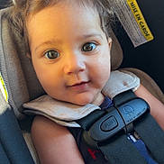 Freya joined the competition — help win amazing prizes! baby, child, car_seat, seatbelt, infant, curly_hair, closeup, portrait, straps, safety, smiling, young, cute, skin, eyes, indoors, seat, warning_label, comfort, sunlight