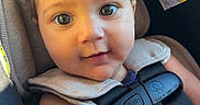 Freya joined the competition — help win amazing prizes! baby, car_seat, child, closeup, comfort, curly_hair, cute, eyes, indoors, infant, portrait, safety, seat, seatbelt, skin, smiling, straps, sunlight, warning_label, young