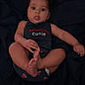 baby, baby_pose, blanket, child, clothing, cute, dark_background, expression, face, foot, hand, indoors, infant, lying_down, onesie, person, portrait, skin, tongue_out, young_child