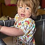 Ivy is registered to the contest to win money with this photo: toddler, child, playpen, dress, winnie_the_pooh, pattern, blue_eyes, curly_hair, indoor, portrait, cute, smiling, young_child, clothing, person, baby, standing, colorful, soft_light, home