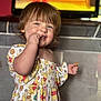 Ivy joined the competition — help win amazing prizes! toddler, child, smiling, dress, winnie_the_pooh, snack, hand, face, blue_eyes, curly_hair, indoor, television, blurred_background, playpen, cute, happy, person, baby, colorful_clothing, portrait