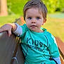 bench, blue_eyes, casual, child, cute, daylight, greenery, nature, outdoor, park, person, portrait, relaxed, short_hair, sitting, sportswear, summer, sunlight, toddler, young_child