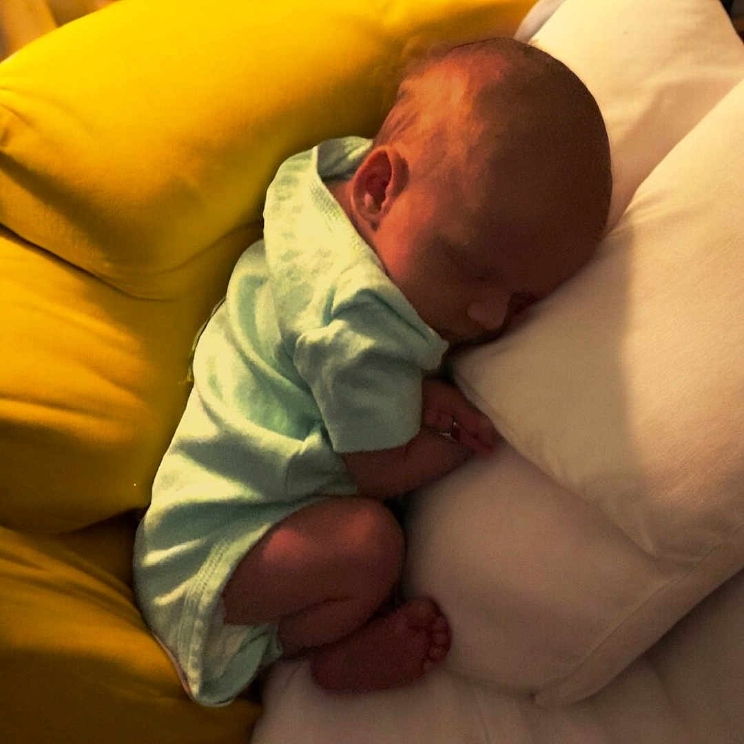 Kora is registered to the contest to win money with this photo: architecture, baby, bed, bedroom, blanket, building, couch, cushion, face, furniture, head, homedecor, hospital, indoors, newborn, person, photography, pillow, portrait, sleeping