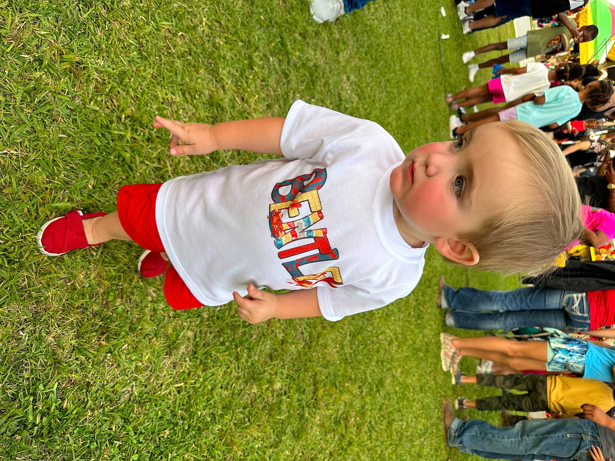 Bentley is registered to the contest to win money with this photo: baby, baby_toddler_clothing, child, event, fun, grass, happy, hat, leisure, pattern, people_in_nature, person, plant, play, recreation, sitting, sleeve, smile, t_shirt, toddler