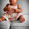 Ciara is registered to the contest to win money with this photo: baby, band_aid, child, clothing, couch, curious, cute, expression, floral_skirt, foot, girl, gray_couch, hand, headband, indoors, infant, pink_top, portrait, sitting, skin