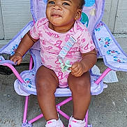 Ciara is registered to the contest to win money with this photo: baby, chair, child, clothing, concrete, cute, determined_expression, earrings, footwear, hair, outdoor, person, pink_shoes, playful, seat, shorts, sitting, sneakers, toddler, toy