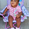 baby, chair, child, clothing, concrete, cute, determined_expression, earrings, footwear, hair, outdoor, person, pink_shoes, playful, seat, shorts, sitting, sneakers, toddler, toy