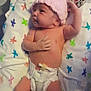 newborn, baby, infant, diaper, pink_hat, blanket, hospital_wristband, lying_down, patterned_blanket, cute, small_hand, small_feet, indoors, pacifier, skin, newborn_care, hospital, sleeping_area, child, portrait