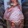 baby, newborn, pacifier, pink_dress, pink_socks, baby_nest, gray_blanket, stars_pattern, sleeping, infant, cute, resting, child, soft_fabric, cozy, lying_down, peaceful, small, portrait, indoors