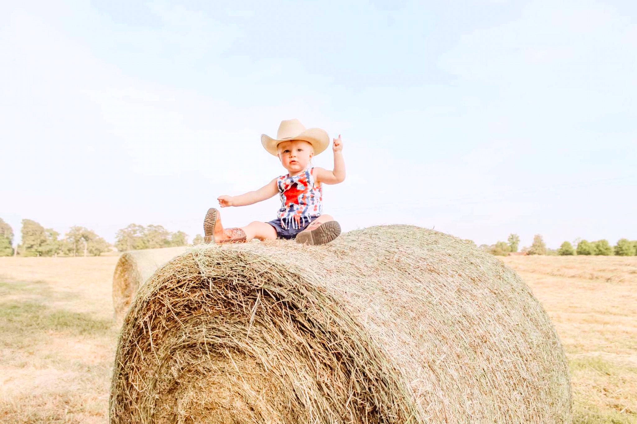 Heather is registered to the contest to win money with this photo: agriculture, cowboy_hat, event, farmer, field, grass, grassland, happy, hat, hay, landscape, people_in_nature, person, plant, prairie, sky, smile, soil, sun_hat, wood