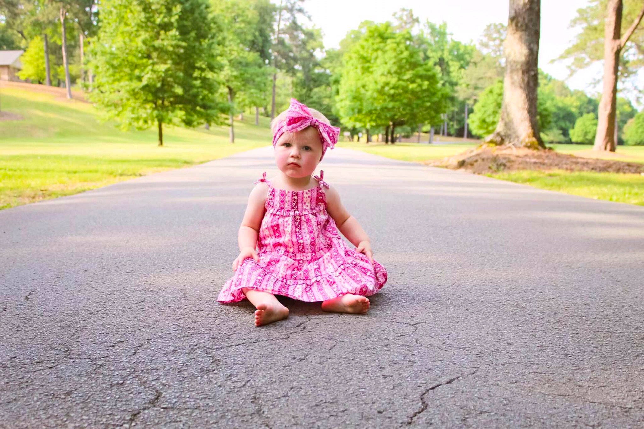 Heather joined the competition — help win amazing prizes! asphalt, baby, dress, fun, grass, green, happy, headwear, landscape, leisure, magenta, people_in_nature, person, pink, plant, recreation, road, road_surface, sky, sunlight