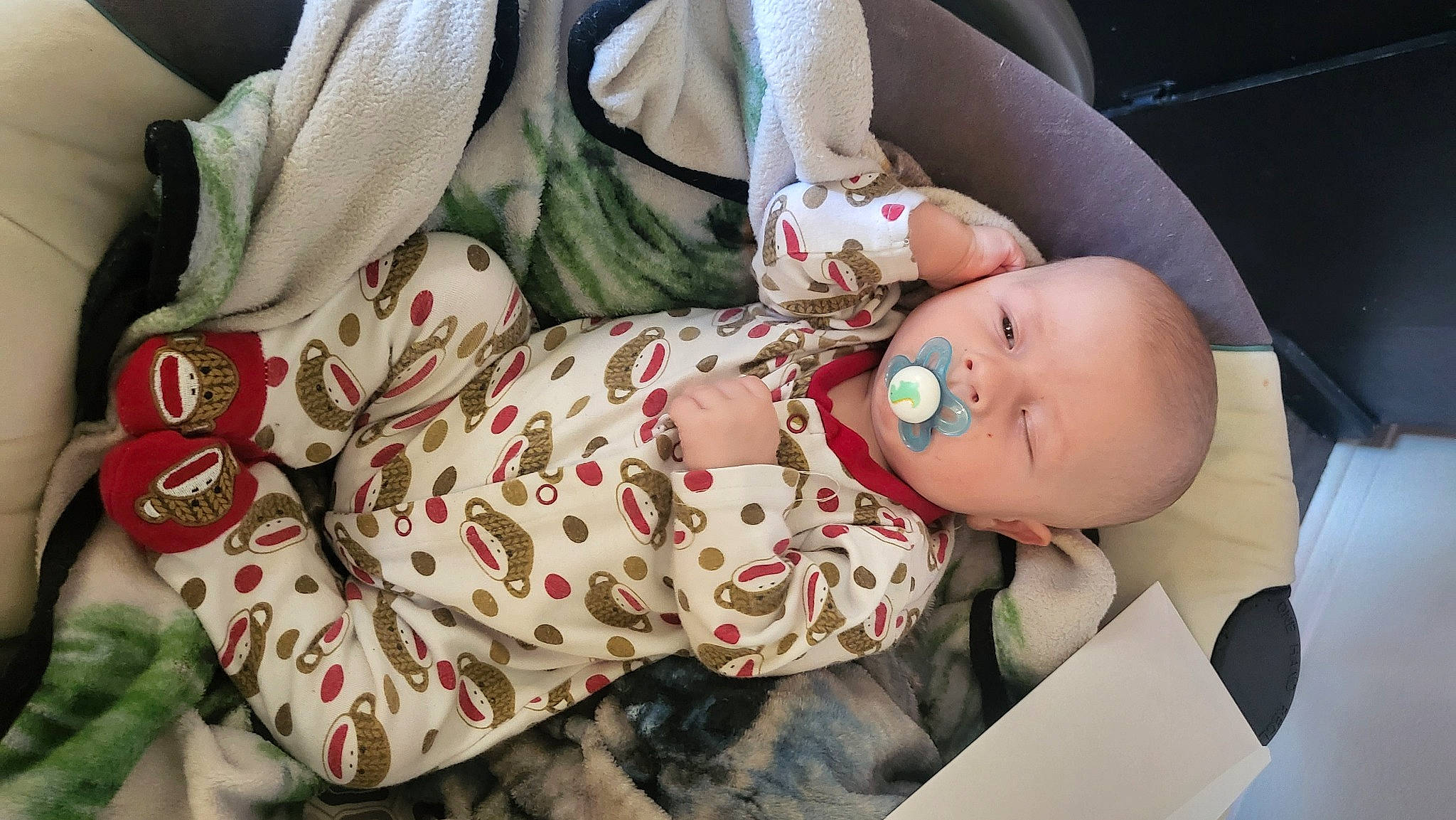 Brylon is registered to the contest to win money with this photo: baby, baby_carriage, baby_products, baby_safety, baby_sleeping, baby_toddler_clothing, child, comfort, doll, hand, head, human_body, leg, linens, mouth, pattern, person, sitting, skin, toddler