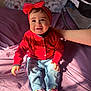 baby, child, smiling, red_sweater, headband, jeans, shoes, indoor, bed, hand, person, happy, cute, portrait, sitting, sunlight, clothing, footwear, infant, casual