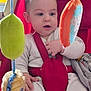 Dino participe au concours pour gagner de l'argent avec cette photo : baby, infant, child, red_baby_seat, toy, hanging_toys, indoor, curious, clothing, seatbelt, soft_toys, child_seat, portrait, person, cute, young_child, baby_clothes, face, hands, sitting