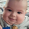 baby, bibs_clip, blue_strap, car_interior, child, chubby_cheeks, closeup, clothing, cute, eyes, face, gray_outfit, happy, indoors, infant, person, portrait, seat, skin, smile