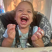 Adaline joined the competition — help win amazing prizes! toddler, child, high_chair, happy, laughing, messy, food, cream, chocolate, face, hands, clothing, straps, indoor, curtain, smile, cute, baby, fun, meal