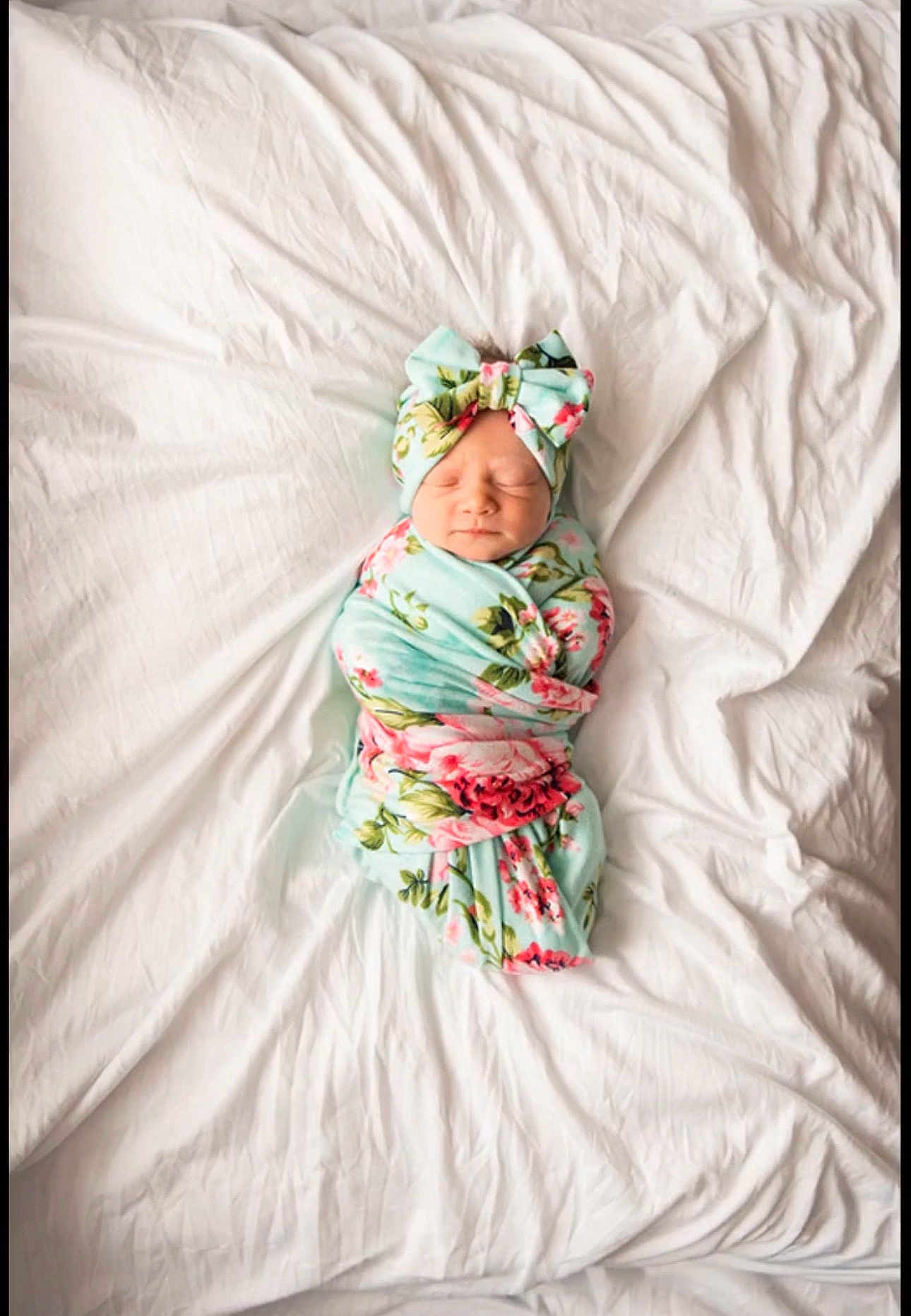 Georgia joined the competition — help win amazing prizes! newborn, baby, swaddled, blanket, bow, headband, floral_pattern, sleeping, white_sheet, bed, cozy, infant, cute, resting, portrait, soft_lighting, wrapped, peaceful, child, indoors