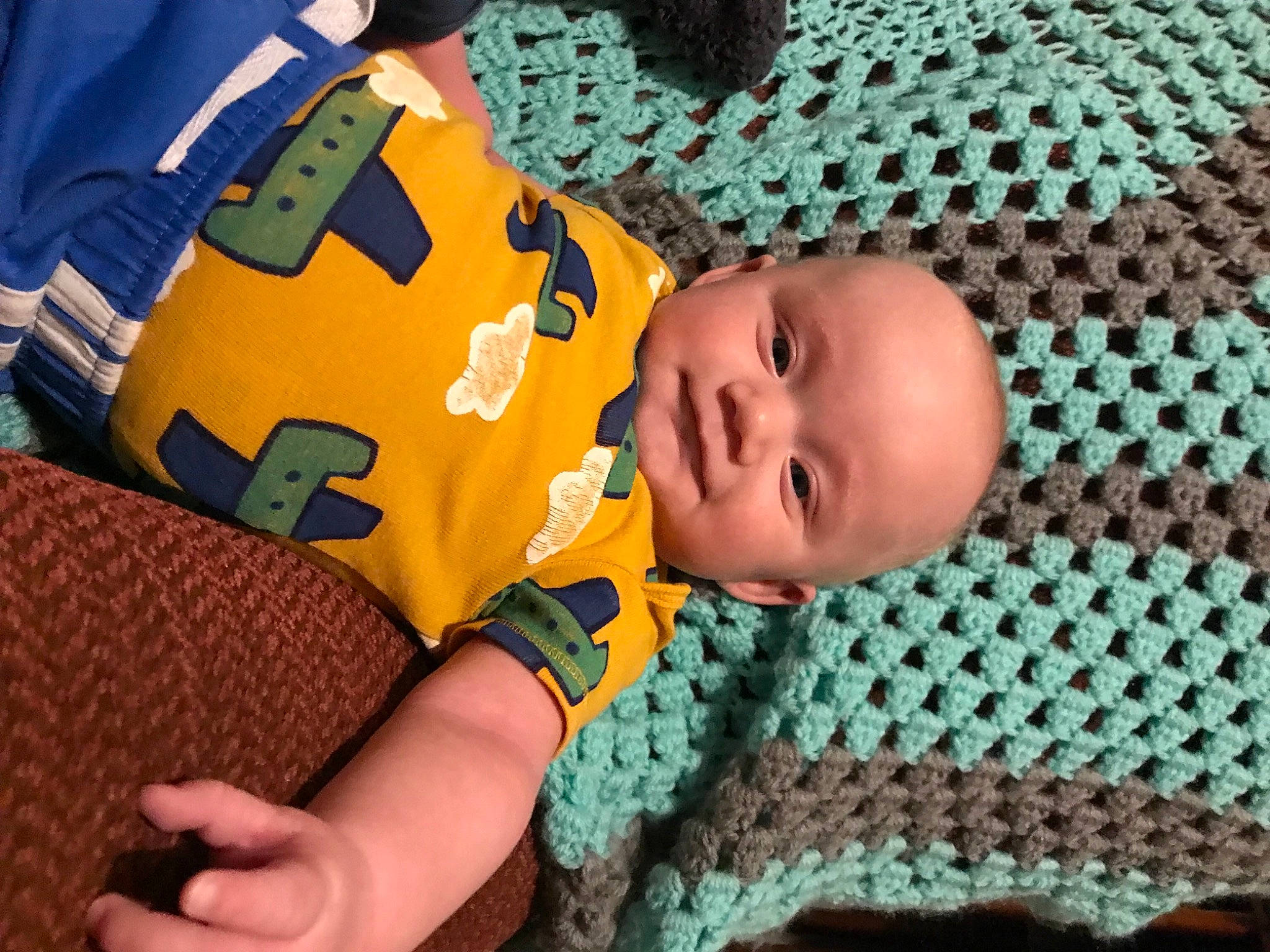 Joshua is registered to the contest to win money with this photo: baby, baby_products, baby_toddler_clothing, cheek, child, comfort, eye, finger, flooring, fun, grass, happy, linens, pattern, person, product, sitting, textile, thumb, toddler