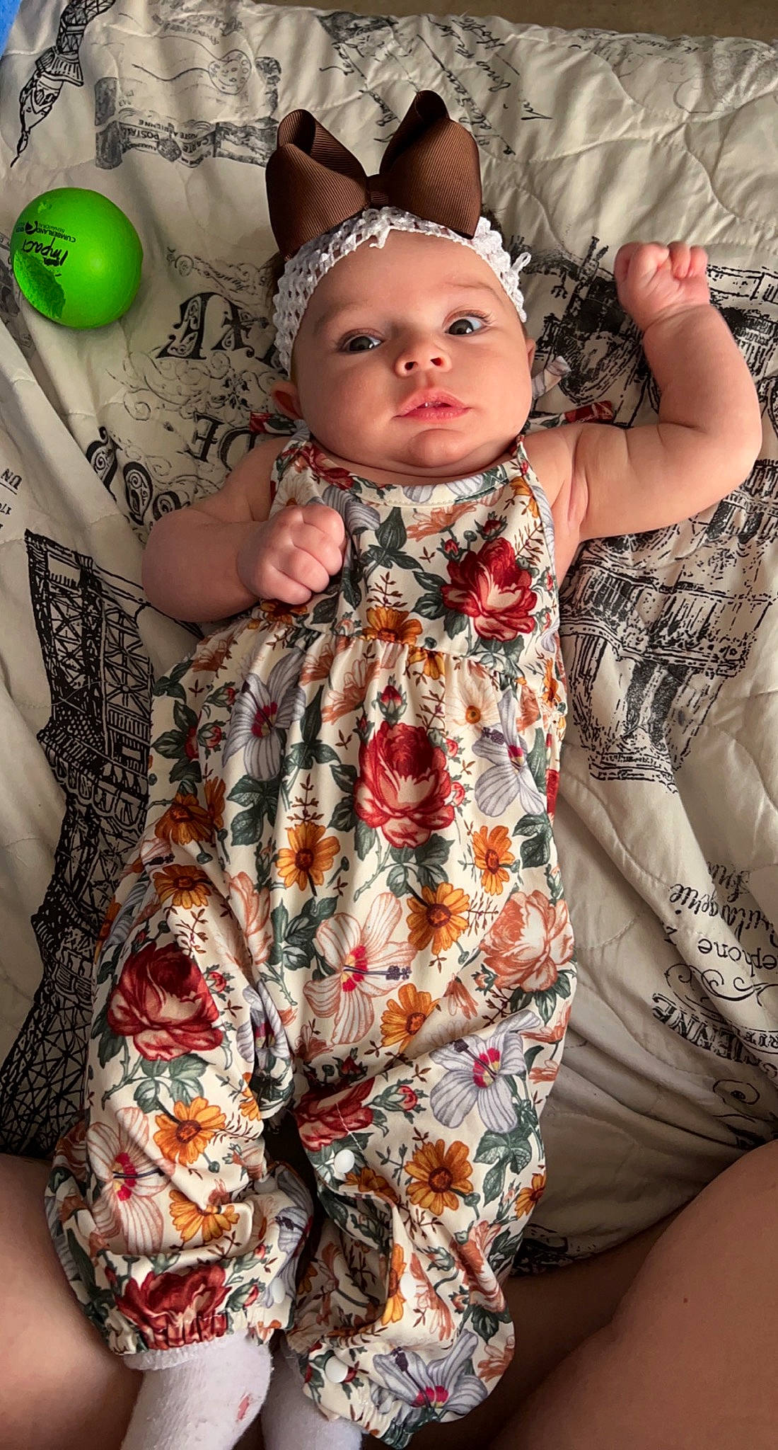 Remi is registered to the contest to win money with this photo: baby, baby_toddler_clothing, child, day_dress, doll, dress, facial_expression, finger, fun, green, happy, head, headgear, headwear, pattern, person, pink, skin, sleeve, textile