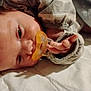 baby, pacifier, infant, sleeping, blanket, clothing, hand, face, skin, closeup, lying_down, indoors, cozy, soft, child, newborn, cute, young, peaceful, resting