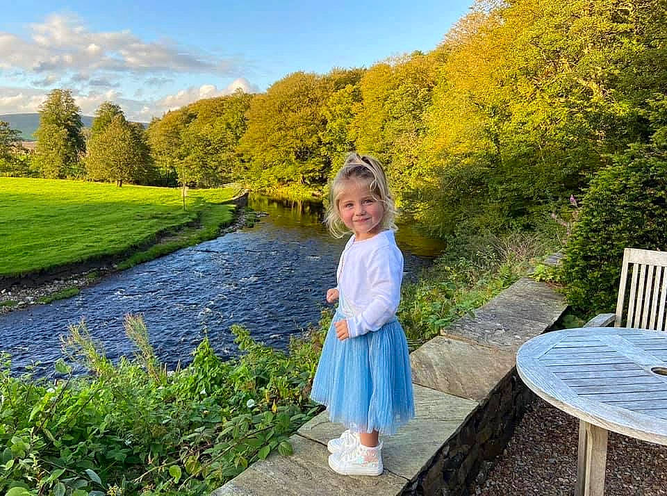 Saskia joined the competition — help win amazing prizes! body_of_water, botany, chair, cloud, grass, green, happy, joy, leaf, leisure, natural_landscape, nature, outdoor_furniture, people_in_nature, person, plant, sky, smile, table, tree