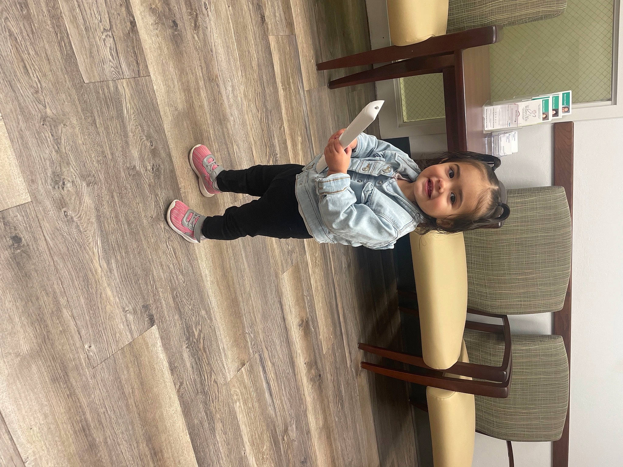 Isella is registered to the contest to win money with this photo: ceiling, child, concrete, elbow, flooring, fun, happy, hardwood, hat, joy, outdoor_shoe, person, plywood, room, sitting, sleeve, smile, toddler, varnish, wood