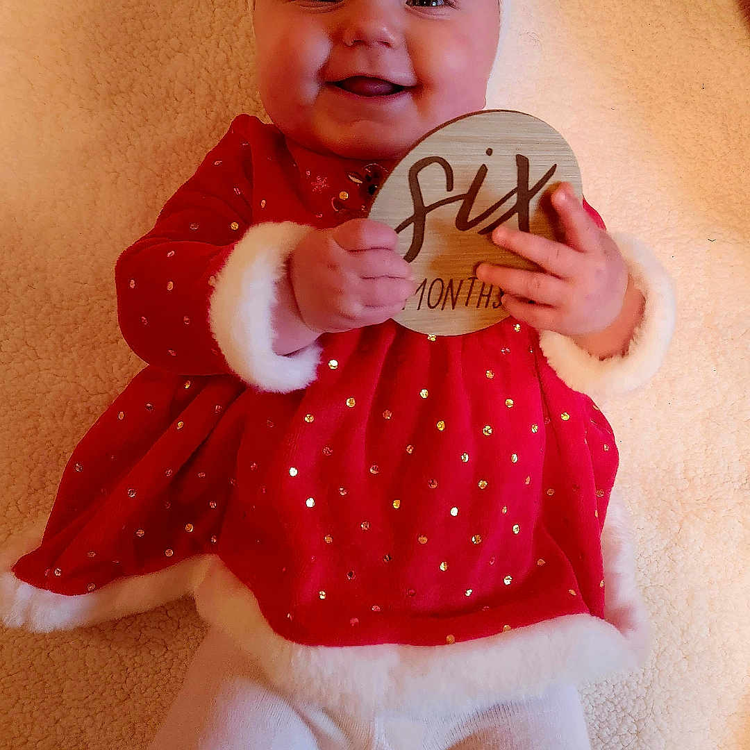 Evelyn is registered to the contest to win money with this photo: baby, bodypart, clothing, coat, costume, face, finger, hand, happy, hat, head, newborn, person, photography, pingpong, pingpongpaddle, portrait, racket, sport, toy