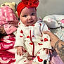 Cheyenne joined the competition — help win amazing prizes! baby, child, smiling, onesie, red_headband, heart_pattern, plush_toys, blanket, bed, hand, tattoo, comfort, indoor, cute, infant, person, soft_toys, pink, white, red