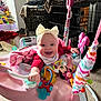 Cheyenne joined the competition — help win amazing prizes! baby, bow, headband, smile, toy, activity_jumper, pink, blanket, indoor, carpet, christmas_tree, decorations, door, floor, baby_clothing, happy, person, infant, playtime, home