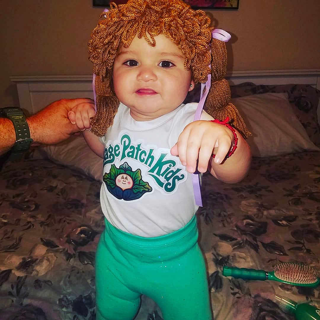 Pandora is registered to the contest to win money with this photo: arm, baby_toddler_clothing, brown_hair, cheek, child, cool, costume, eye, fictional_character, hair, happy, head, person, red_hair, sleeve, smile, t_shirt, toddler